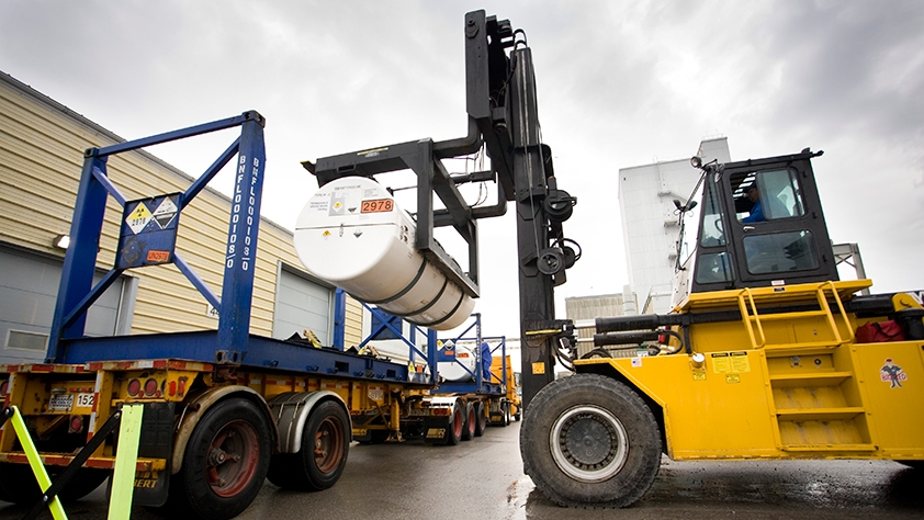 forklift lifting UF6 shipping cylinders