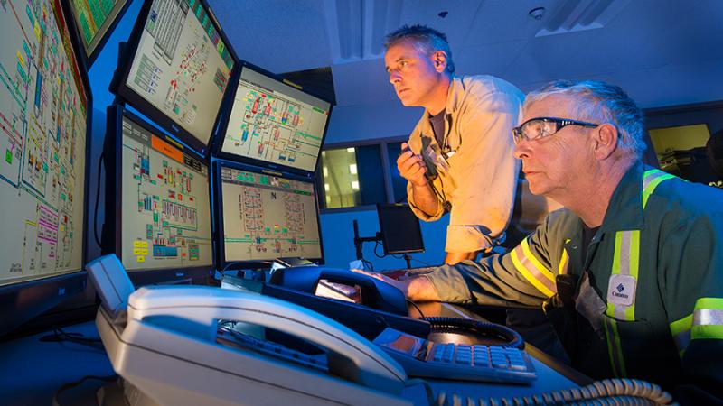 Workers monitor uranium refinement processes. 